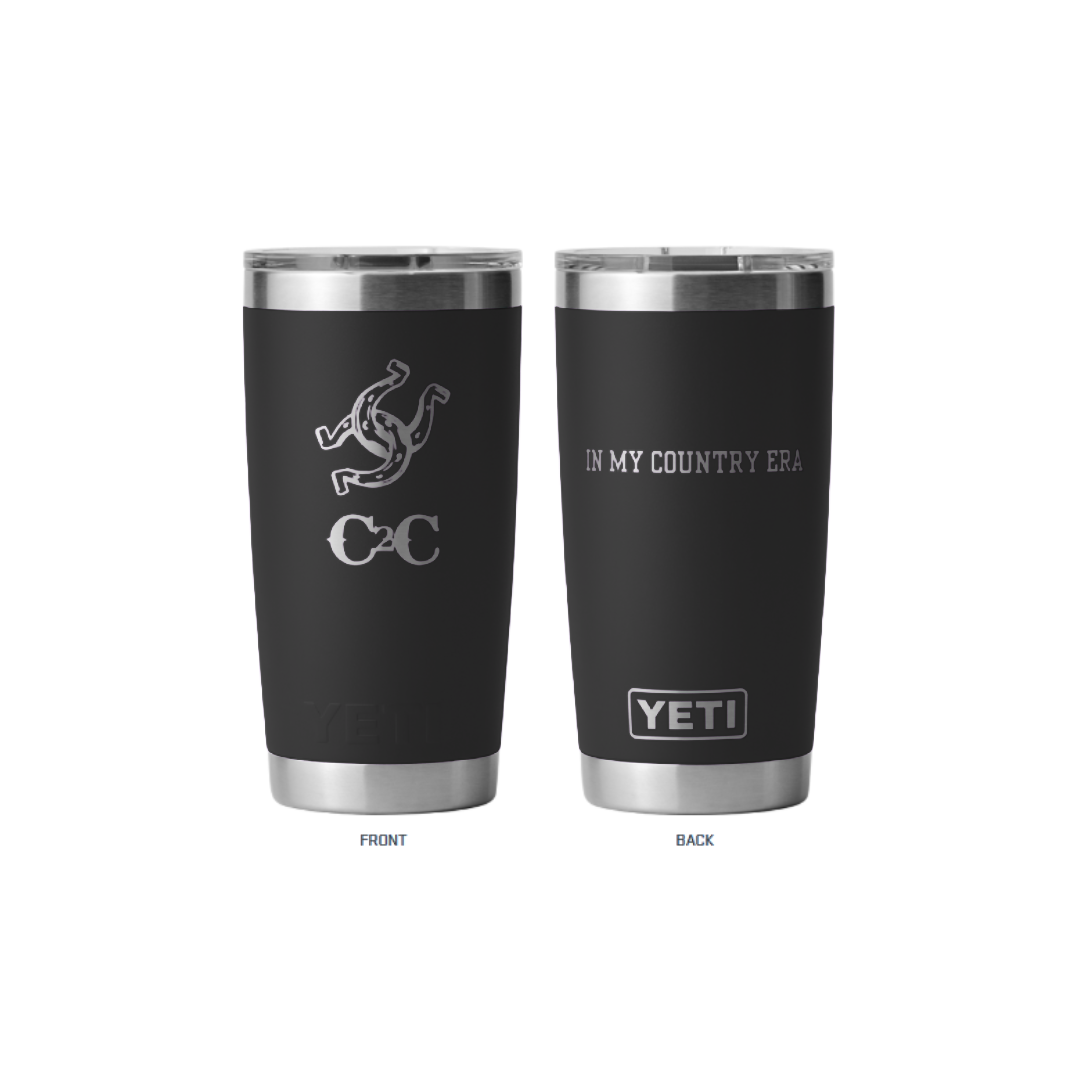 Two black insulated Yeti Tumbler Black cups by 2026 with stainless steel rims and bases. The front shows a serpent and “CC” logo; the back has “IN MY COUNTRY ERA” above the YETI logo—ideal for festivals.