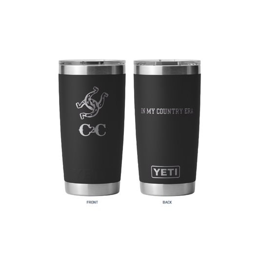 Two black insulated Yeti Tumbler Black cups by 2026 with stainless steel rims and bases. The front shows a serpent and “CC” logo; the back has “IN MY COUNTRY ERA” above the YETI logo—ideal for festivals.