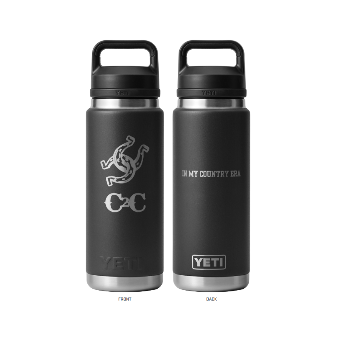 Two black durable 2026 Yeti Bottles. The front displays a horseshoe, cowboy hat, and “CC.” The back says “IN MY COUNTRY ERA” in white. Insulated and perfect for any adventure.