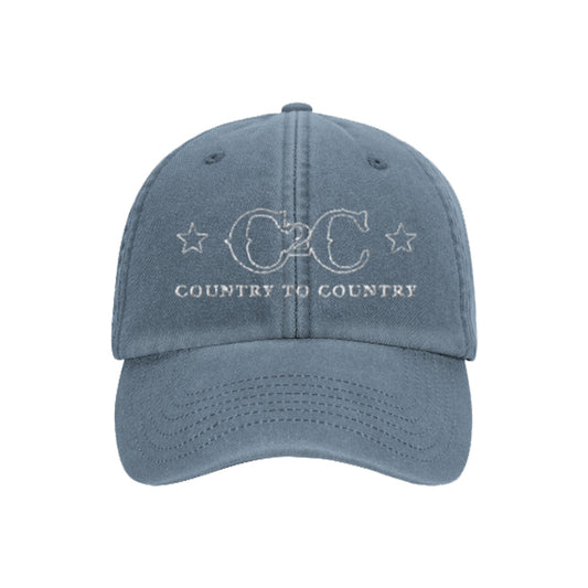 The C2C Country To Country Store Dad Cap is a blue baseball cap with white C2C Country to Country embroidery and two stars, one on each side of the text.