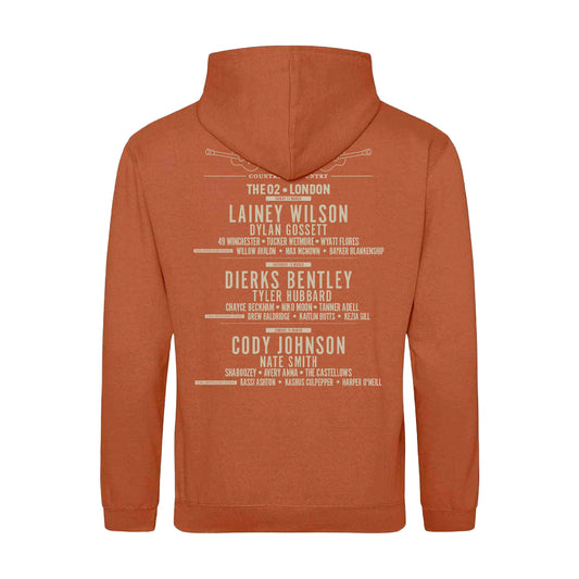 The 2025 Ginger Biscuit London Hoodie by C2C Country To Country Store is a brown hoodie featuring country music artists and venues like Lainey Wilson, Dierks Bentley, Cody Johnson, and The O2–London on the back.