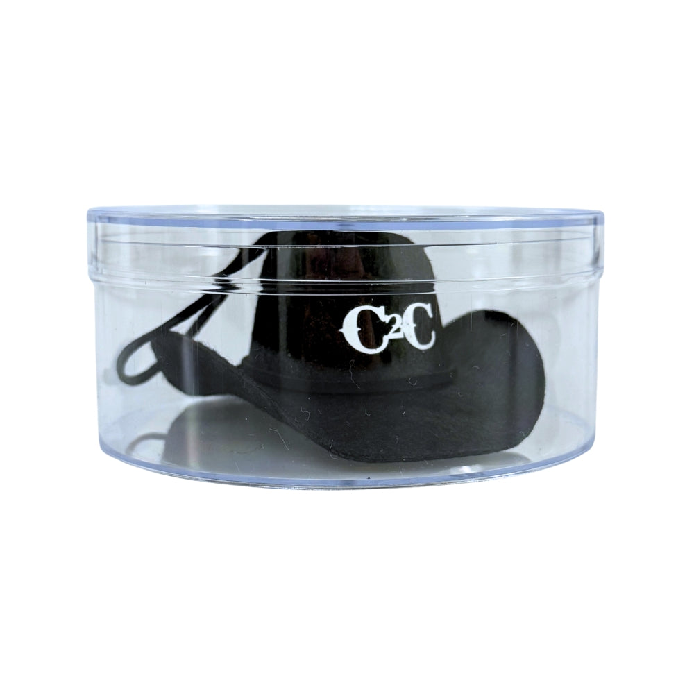The C2C Country To Country Black Cowboy Hat Bauble, featuring a silver C2C logo, is displayed inside a clear round plastic container with a lid against a white background.