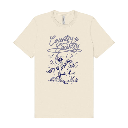 The Rodeo Rider Natural T Shirt by C2C Country To Country features a navy cowboy-and-horse graphic with “Country to Country” in cursive, printed eco-friendly for lasting quality and style.