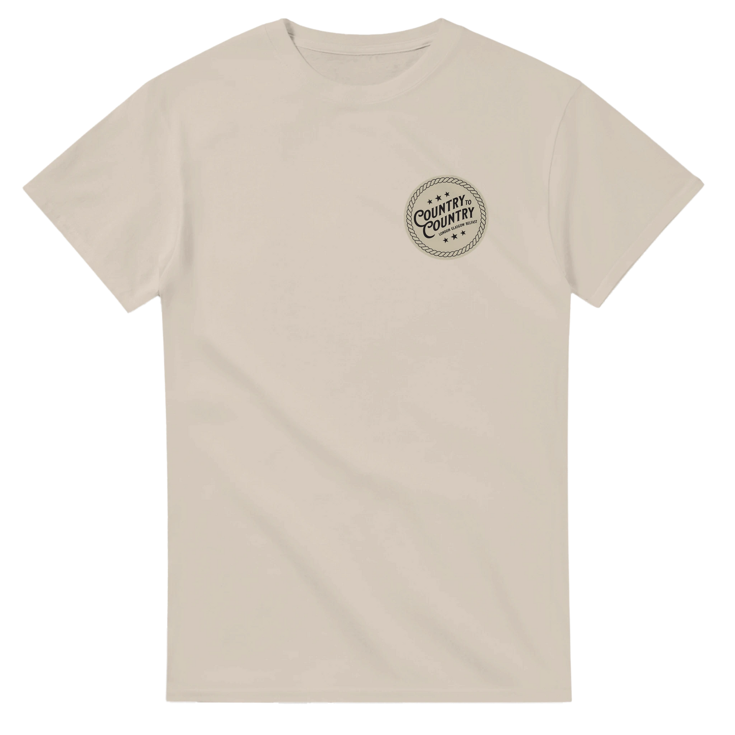 The C2C Country To Country 2025 London Line Up T-Shirt is a plain beige tee with a seamless double-needle collar, short sleeves, and crew neckline. A small black circular logo with text appears on the left chest. Made to order.
